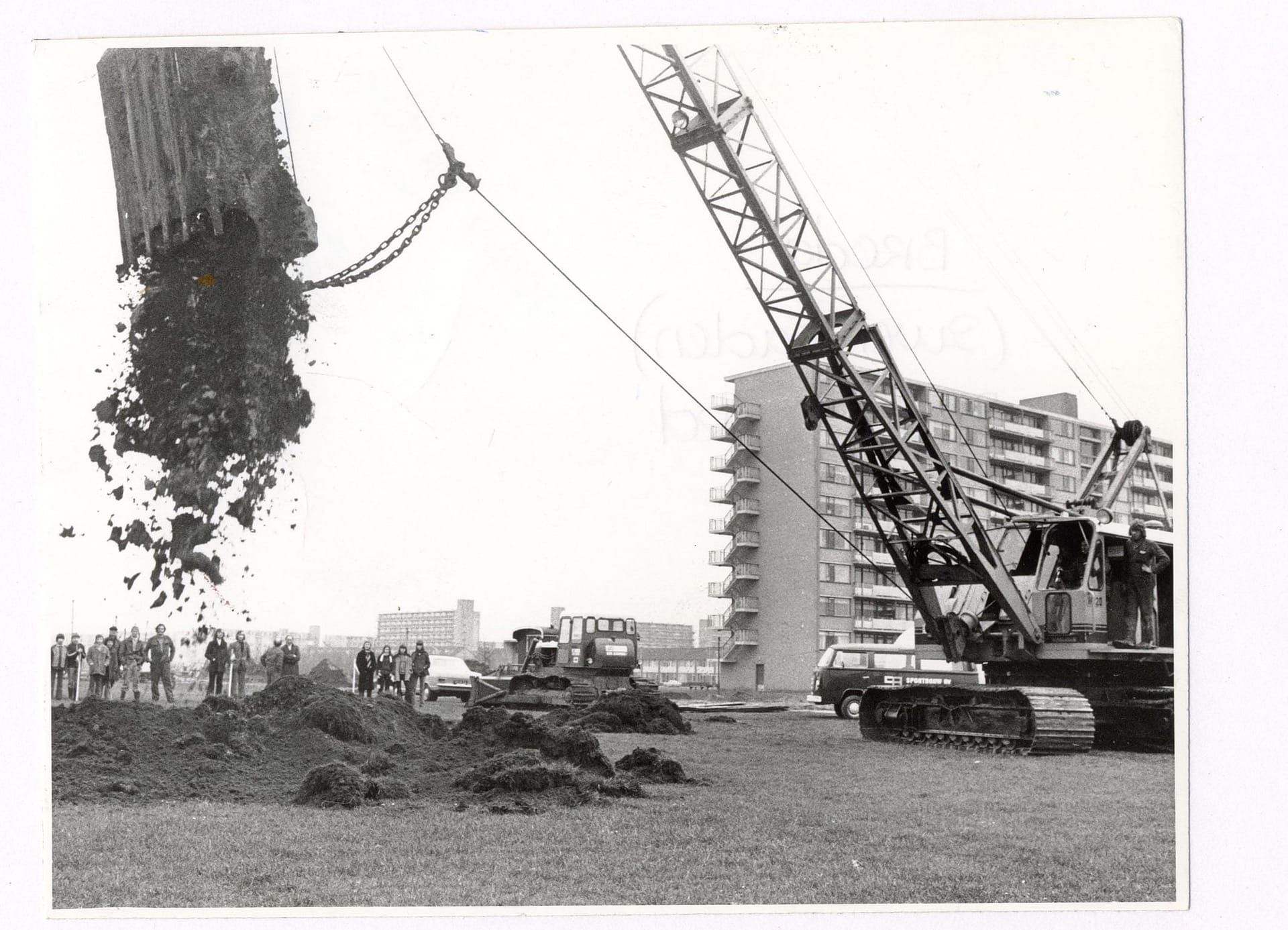 Wethouder J. Mans doet met hijskraan de eerste grondverplaatsing voor de bouw van zwembad De Wisselslag 1974 Wethouder J. Mans doet met hijskraan de eerste grondverplaatsing voor de bouw van zwembad De Wisselslag 1974